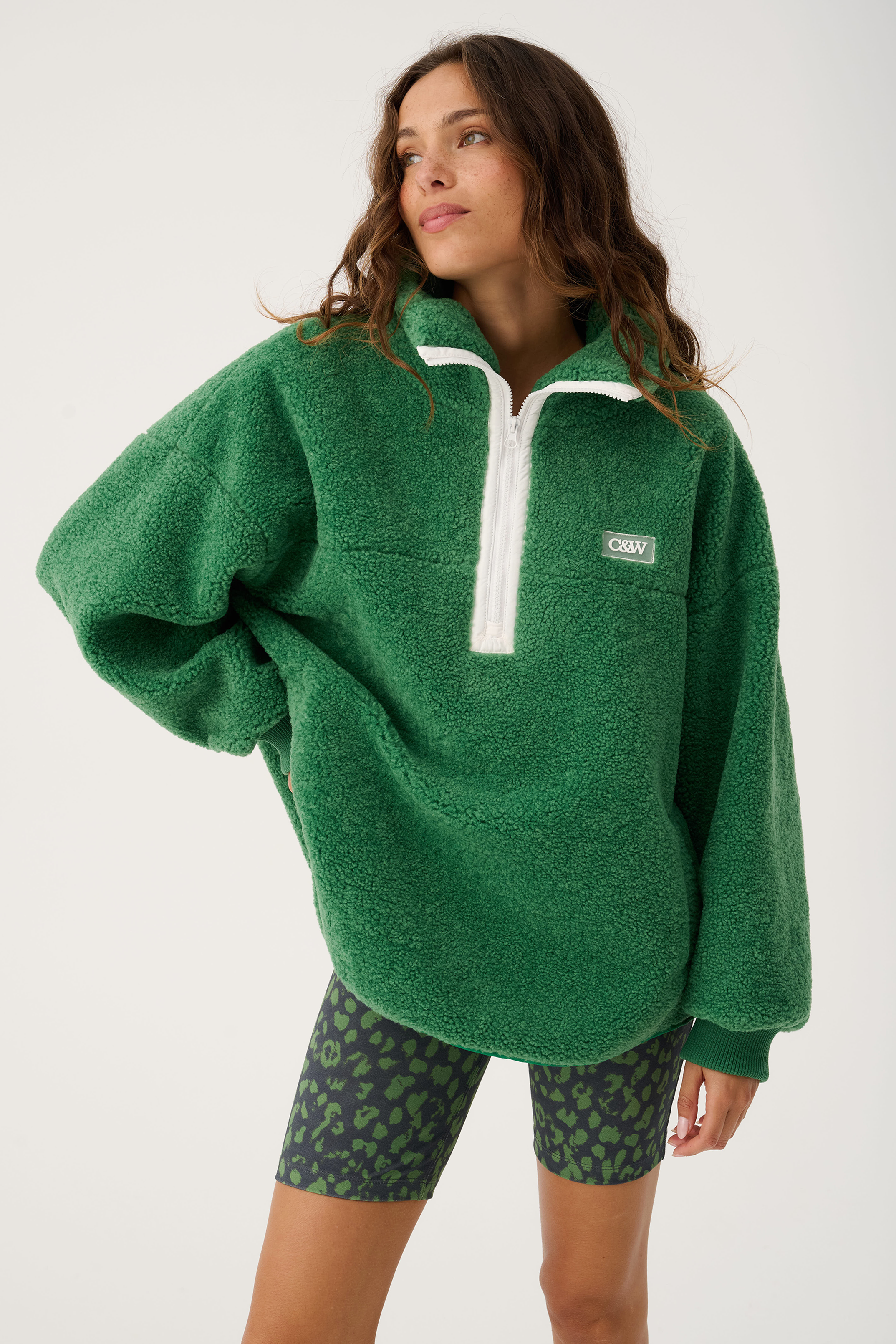 Front view of Celeste Pullover in tide green showing oversized fit and white quarter zip closure
