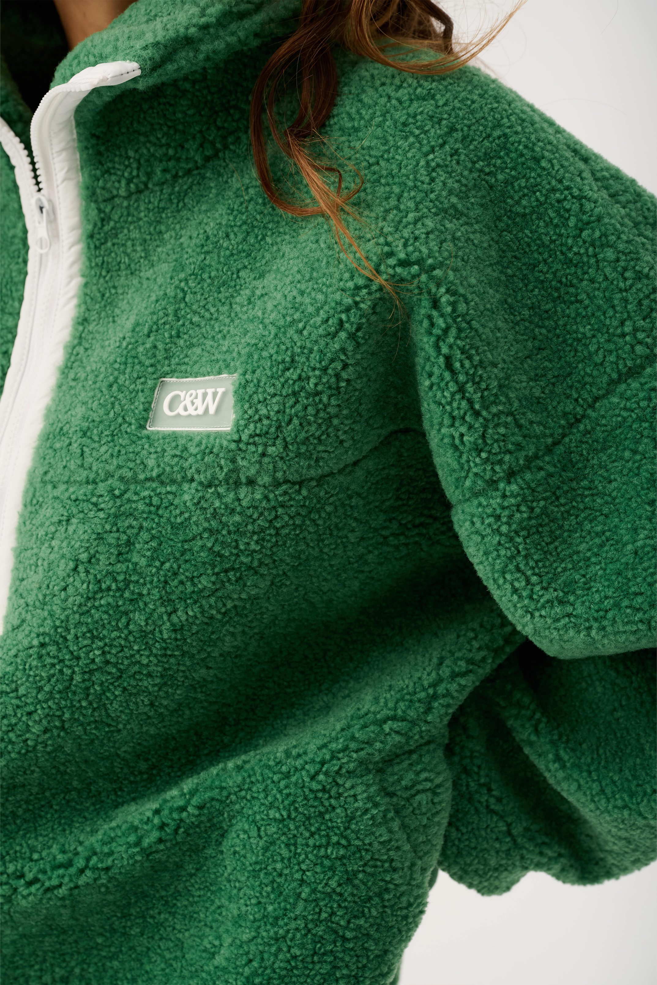 Close-up detail of Celeste Pullover showing textured fleece fabric and brand patch