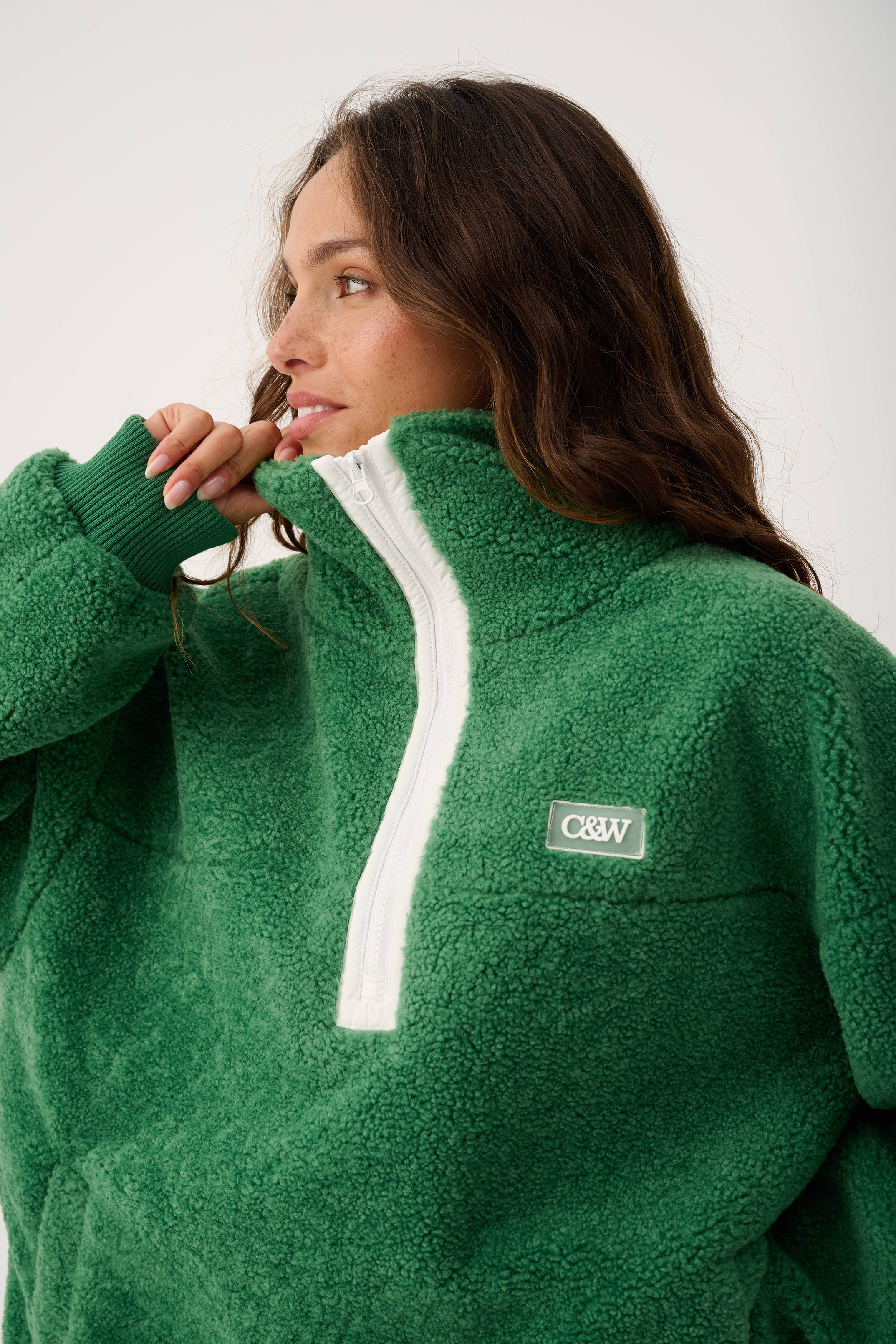Side angle of Celeste Pullover showing quarter zip detail and ribbed cuff construction