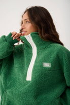 Side angle of Celeste Pullover showing quarter zip detail and ribbed cuff construction