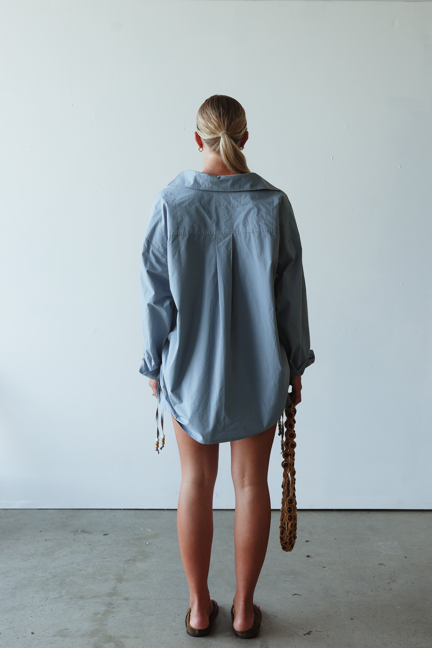 back view of model wearing Celine Shirt - cornflower by By Billie