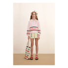 girl wearing pink Cherries Sweater by Tiny Cottons