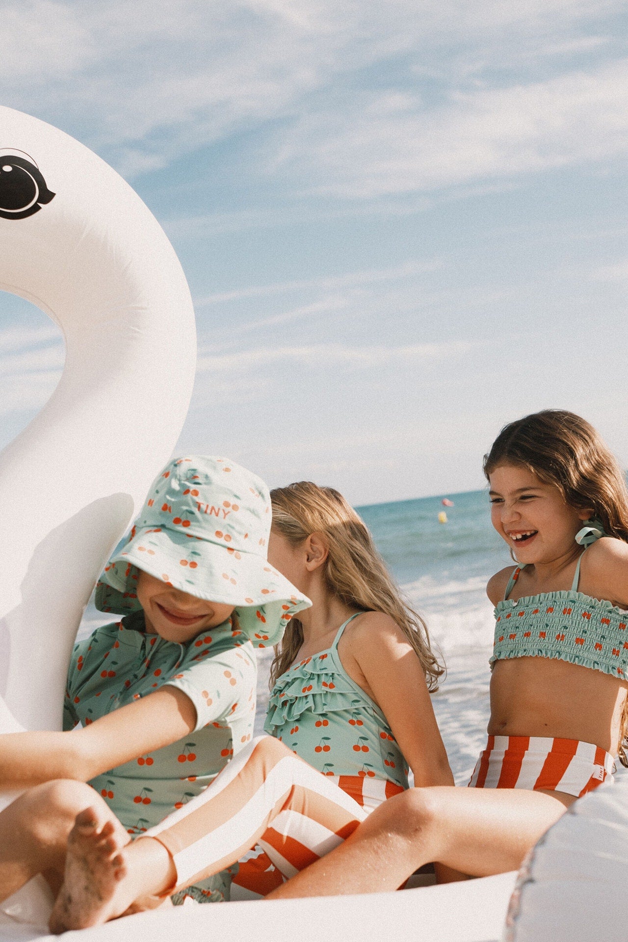 Young girl in the Cherries Smock Swim Set | Tiny Cottons top 