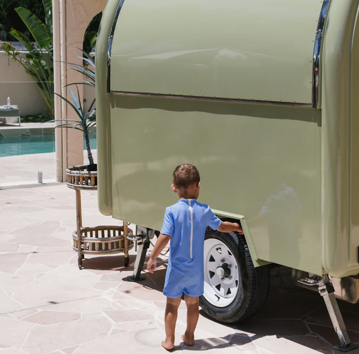 Back view of young boy in the Ciao Tutti Pesci One Piece Swim - Pool Blue | Golden Children