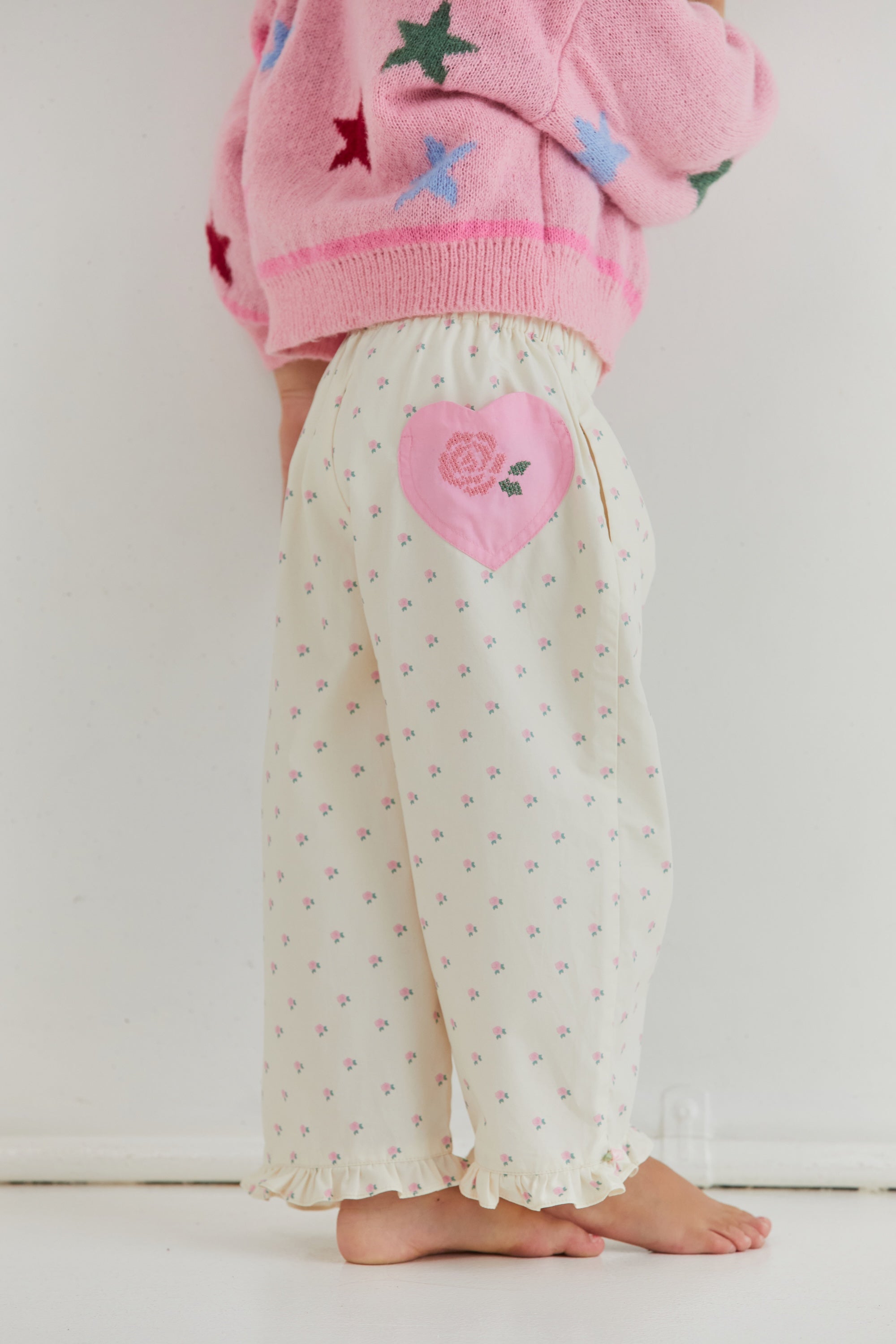 Back view detail of Cleo Pant showing pink heart patch and elastic waistband