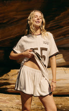 lady wearing the Club 55 Shorts - Cocoa | Indigo & Wolfe. Made from organic cotton pointelle fabric with brown stripe details
