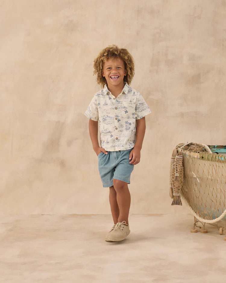 Boy wearing cream collared shirt with blue ocean print