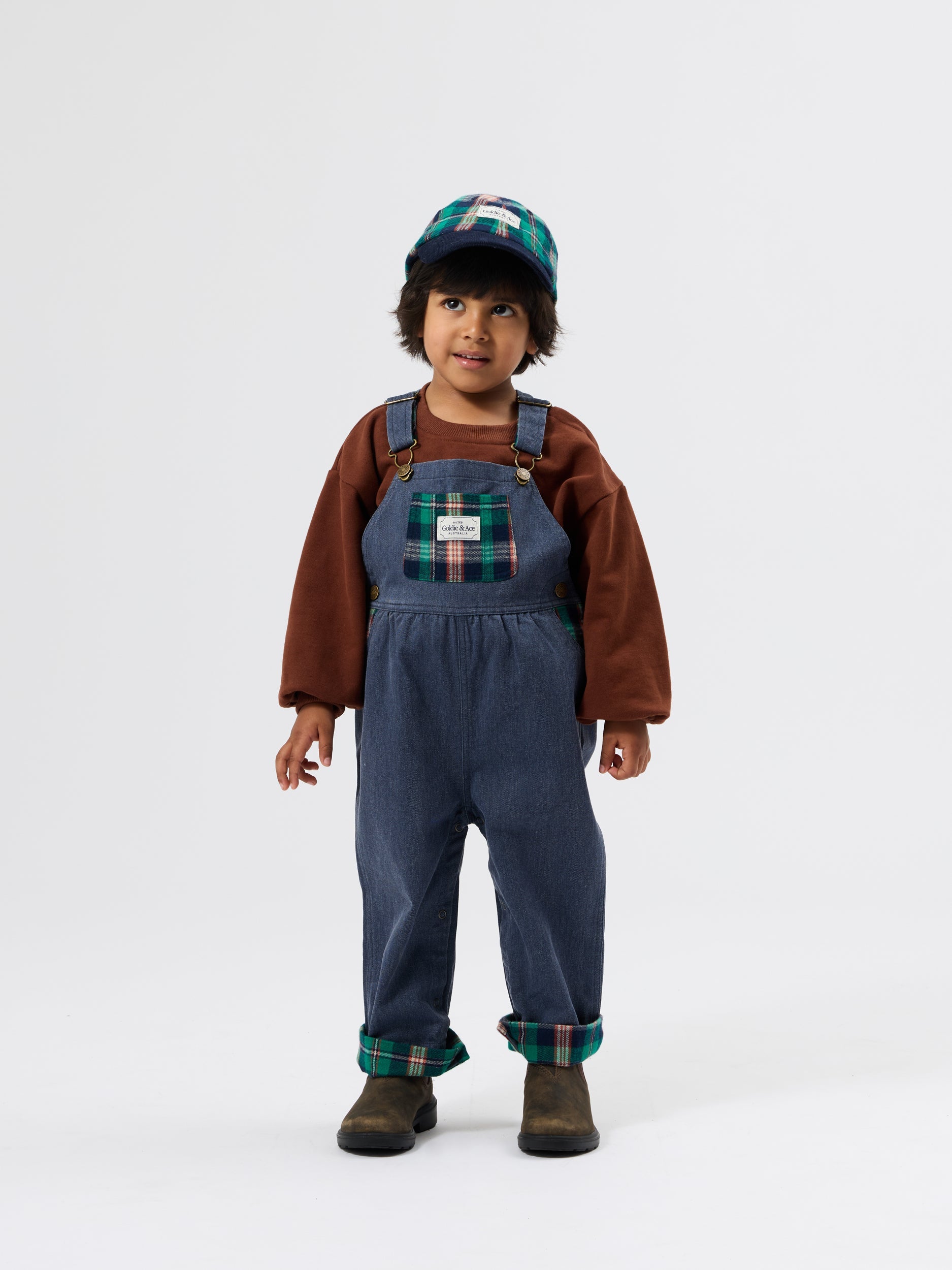 Brown embroidered sweater with long sleeves and crew neck styled with denim overalls