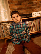 Brown embroidered sweatpants paired with green plaid shirt showing casual comfortable styling