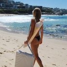 Beach umbrella assembly process showing easy setup of Sunnylife compact shade structure