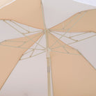 Two person capacity demonstrated under butternut colored beach umbrella canopy on sand