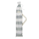 Compact beach umbrella folded in carry bag with shoulder strap for easy transport and storage