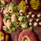 beautiful woven wool details of the Coralie Woven Wall Hanging by Sage & Clare in green, pinks, cream and burgundy