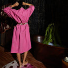 Model adjusting Cosmin Cotton Robe belt demonstrating the relaxed fit and luxurious lounge styling potential