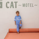 Boy wearing the Cowboys & Dolphins T-shirt - Pool Blue | Golden Children and matching pants