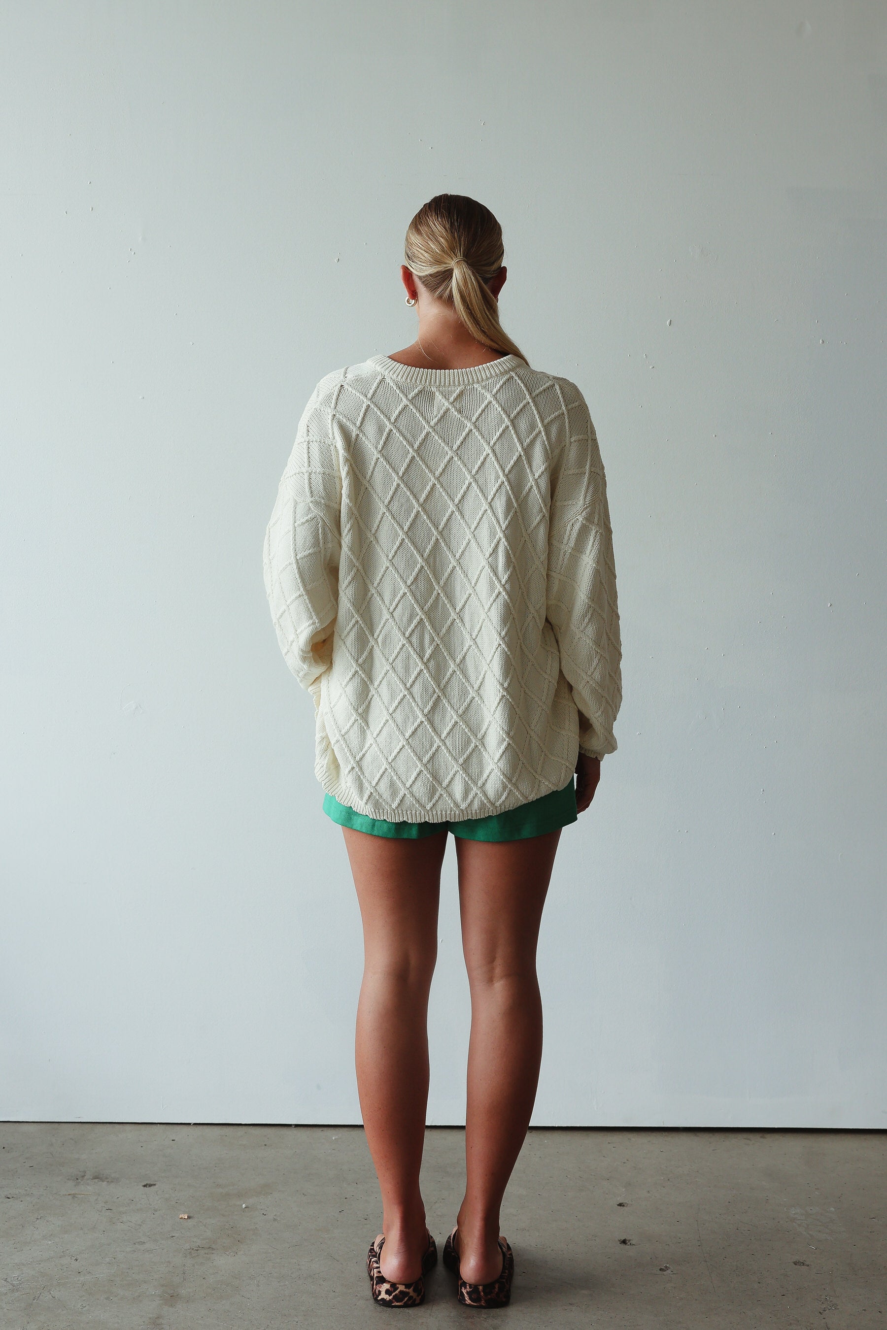 back view of model wearing Crochet Knit Cardigan - cream by By Billie