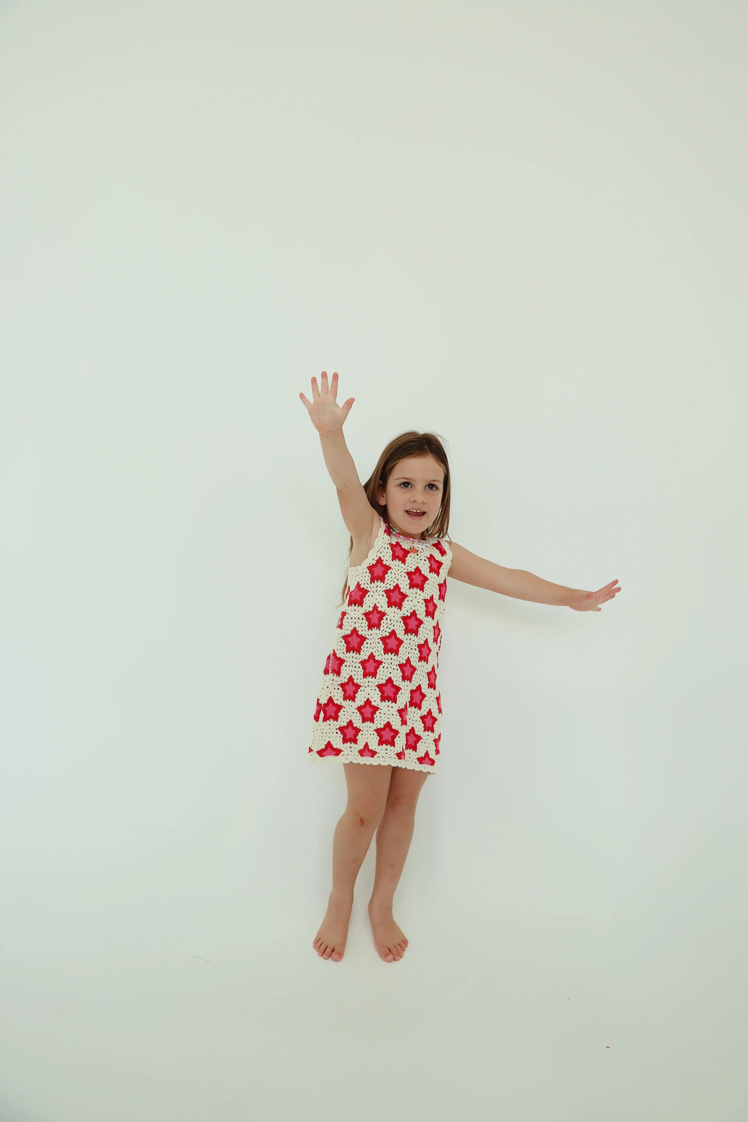 girl wearing dress by BY Billie with pink and red stars