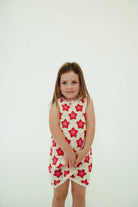 girl wearing cotton crochet dress with pink and red stars