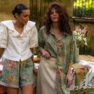 Two models styled in Wandering Folk pieces showcasing Dahlia shirt with complementary outfit
