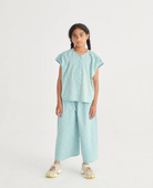 Front view of girl wearing the Daisy Mosaic All Over Woven Culotte Pants - Light Blue | Bobo Choses