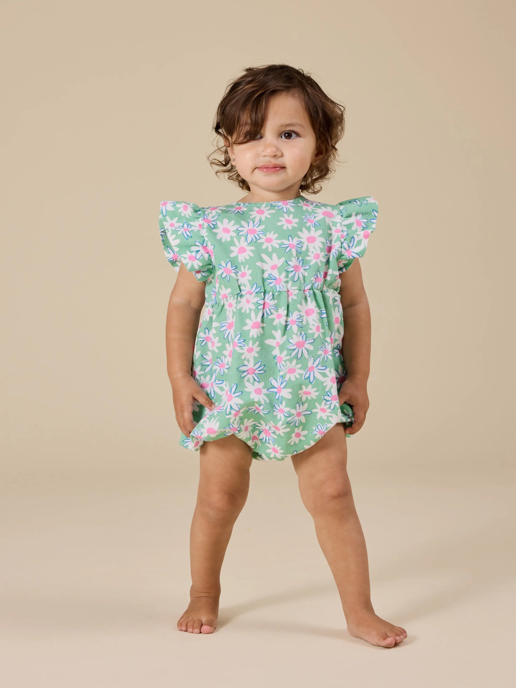 Green romper with pink and white daisies