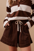 Model wearing brown shorts with draw string and pockets - Darcy Relaxed Everyday Short Chocolate by Ceres Life 