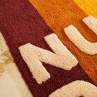 Fabric details of Dariel Nudie Rudie Bath Mat Kent by Sage and Clare - brown, orange and yellow sunset colours - Made from GOTS certified organic cotton