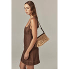 model holding bag - Dawn Raffia Fringe Crossbody by Helen Kaminski