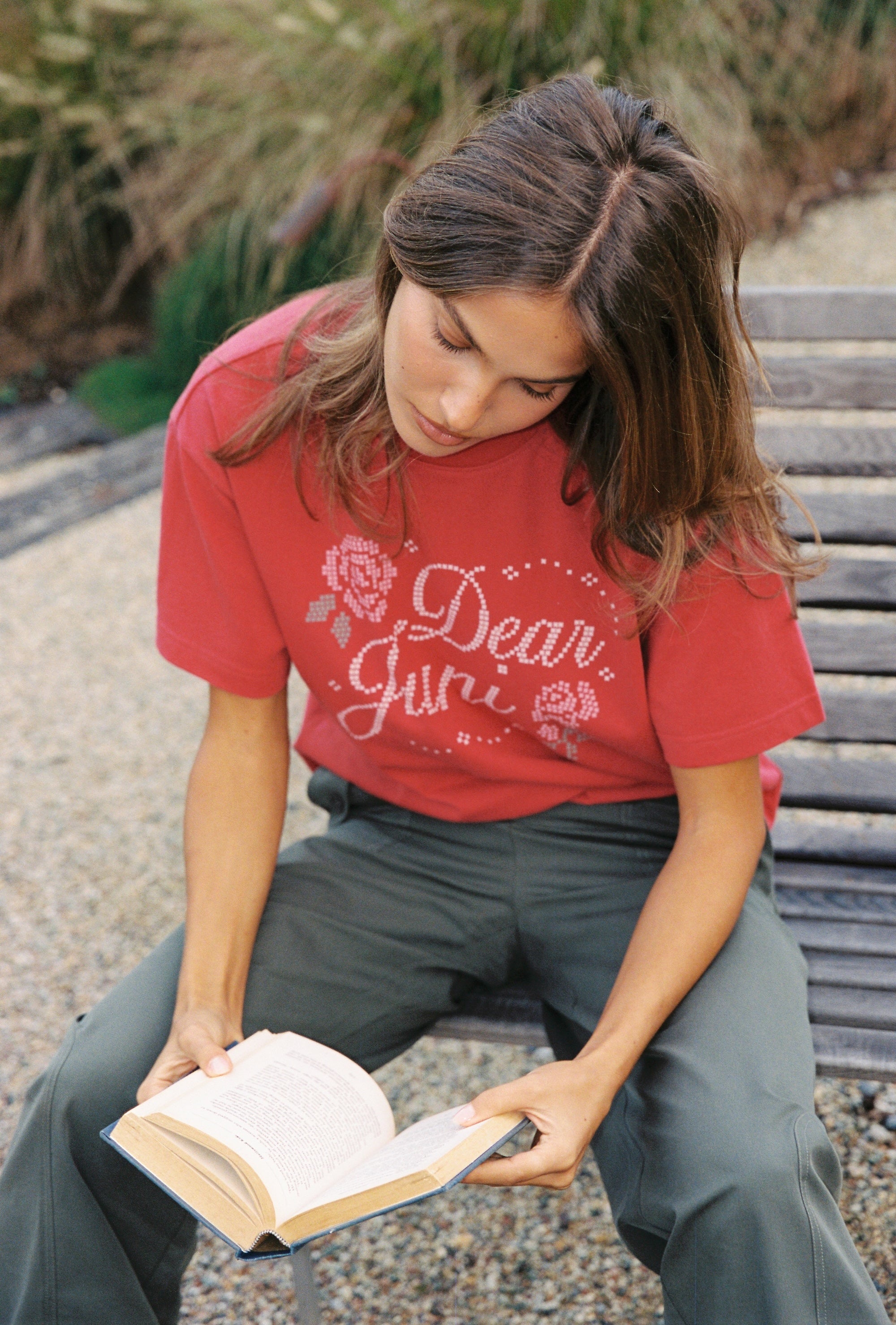 Close-up view of red Dear Juni Tee featuring white rhinestone Dear Juni text and decorative elements