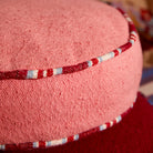 close up fabric details of Delana Round Cushion - Hibiscus by Sage & Clare