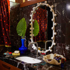 Aspen Gold wave soap dish on a dark marble bathroom vanity with a decorative mirror and styling accessories