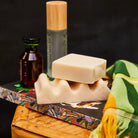 Pearl wave soap dish topped with a bar of soap, styled on a bamboo tray with bathroom accessories