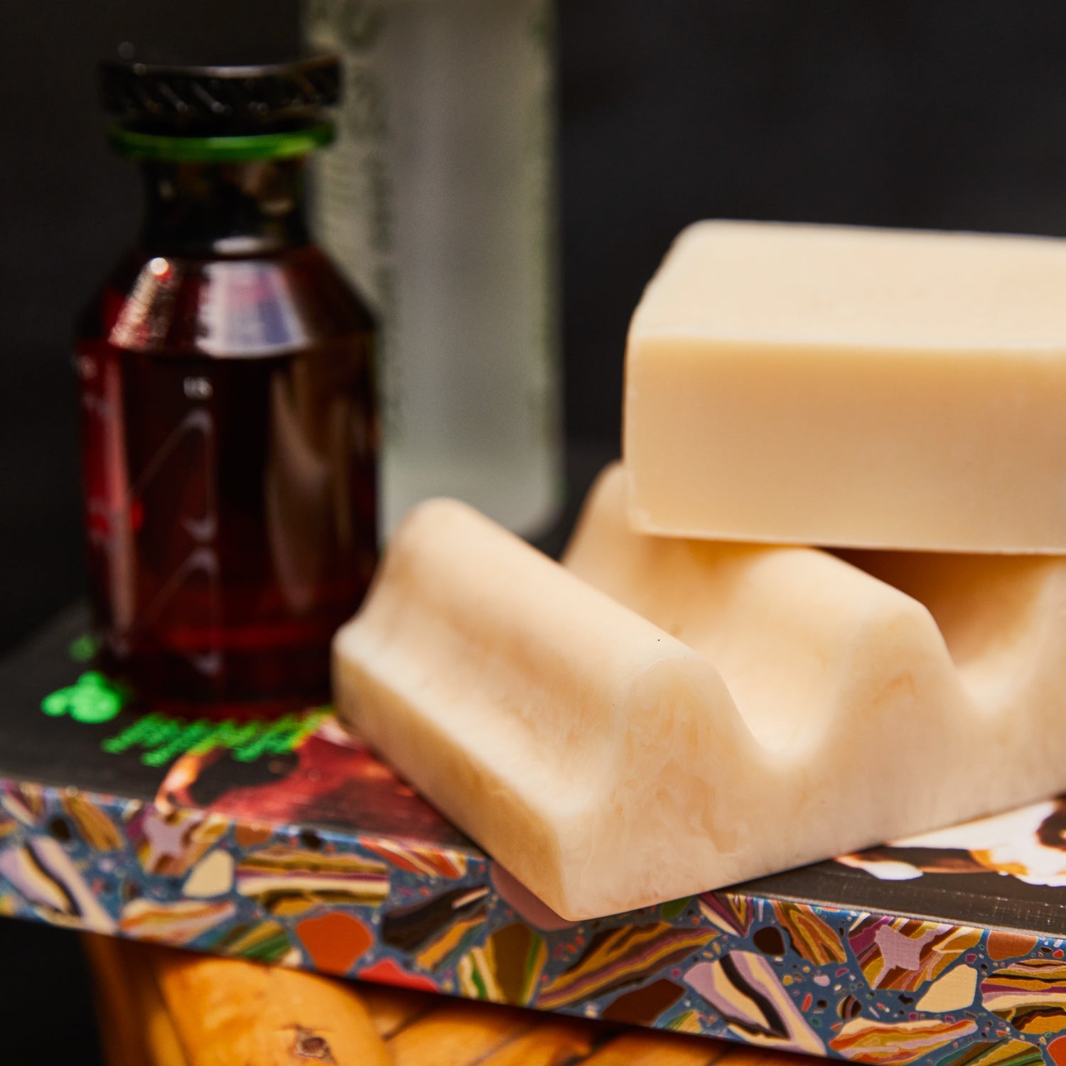 Close-up of Pearl wave soap dish with a cream bar of soap balanced on its ridged surface