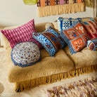 Devi Velvet Cushion - Blue Jean by Sage & Clare displayed with other colourful cushions