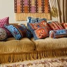 Devi Velvet Cushion - Blue Jean by Sage & Clare displayed with other bright and colourful cushions