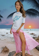 Women wearing light blue Dolphin Yin Yang T-Shirt by Sea Street with white stripes on sleeves