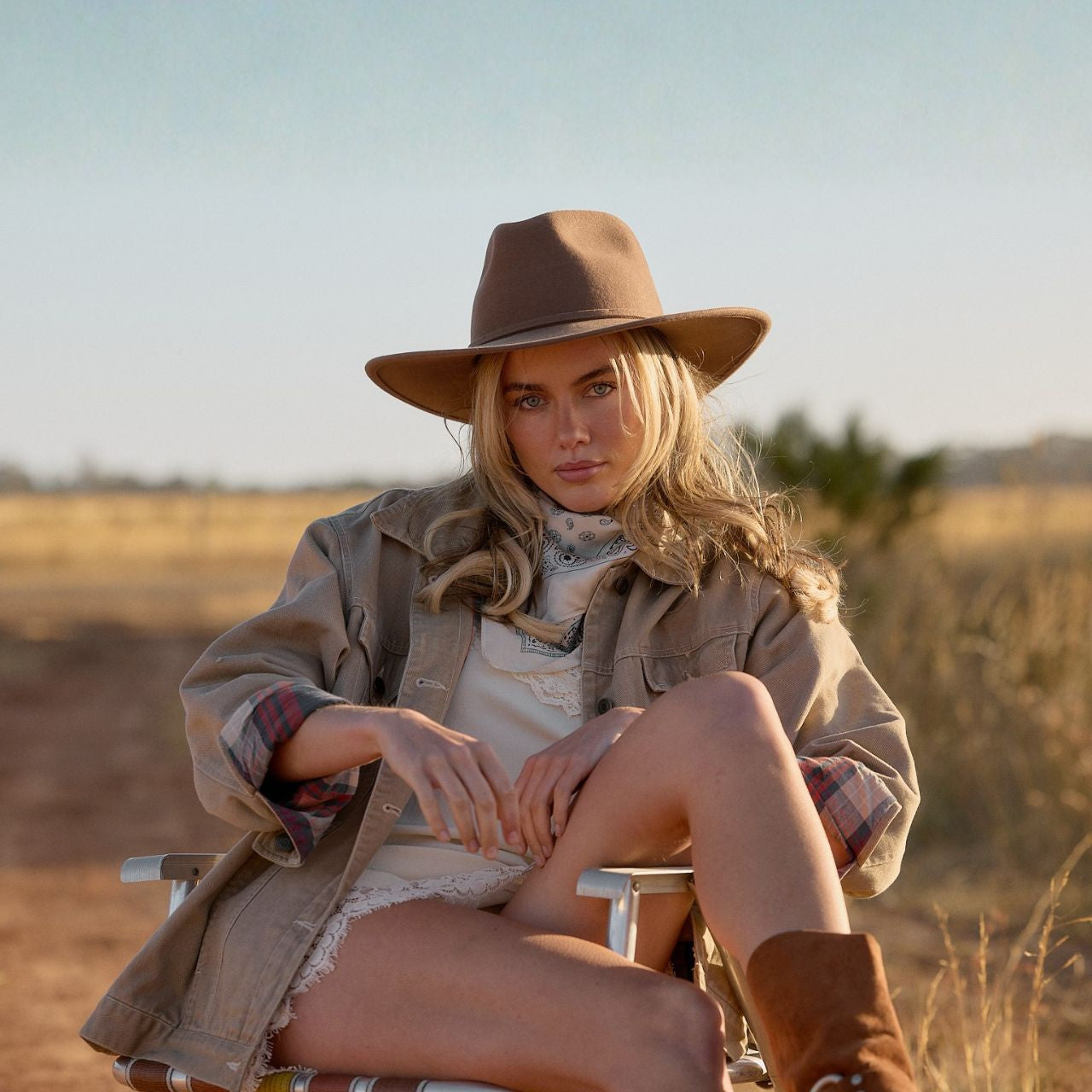 Golden hour lighting on dusty brown packable outback hat showing warm tones and felt texture