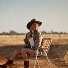 Dusty brown packable outback hat worn with wide brim showing classic western style in outdoor setting