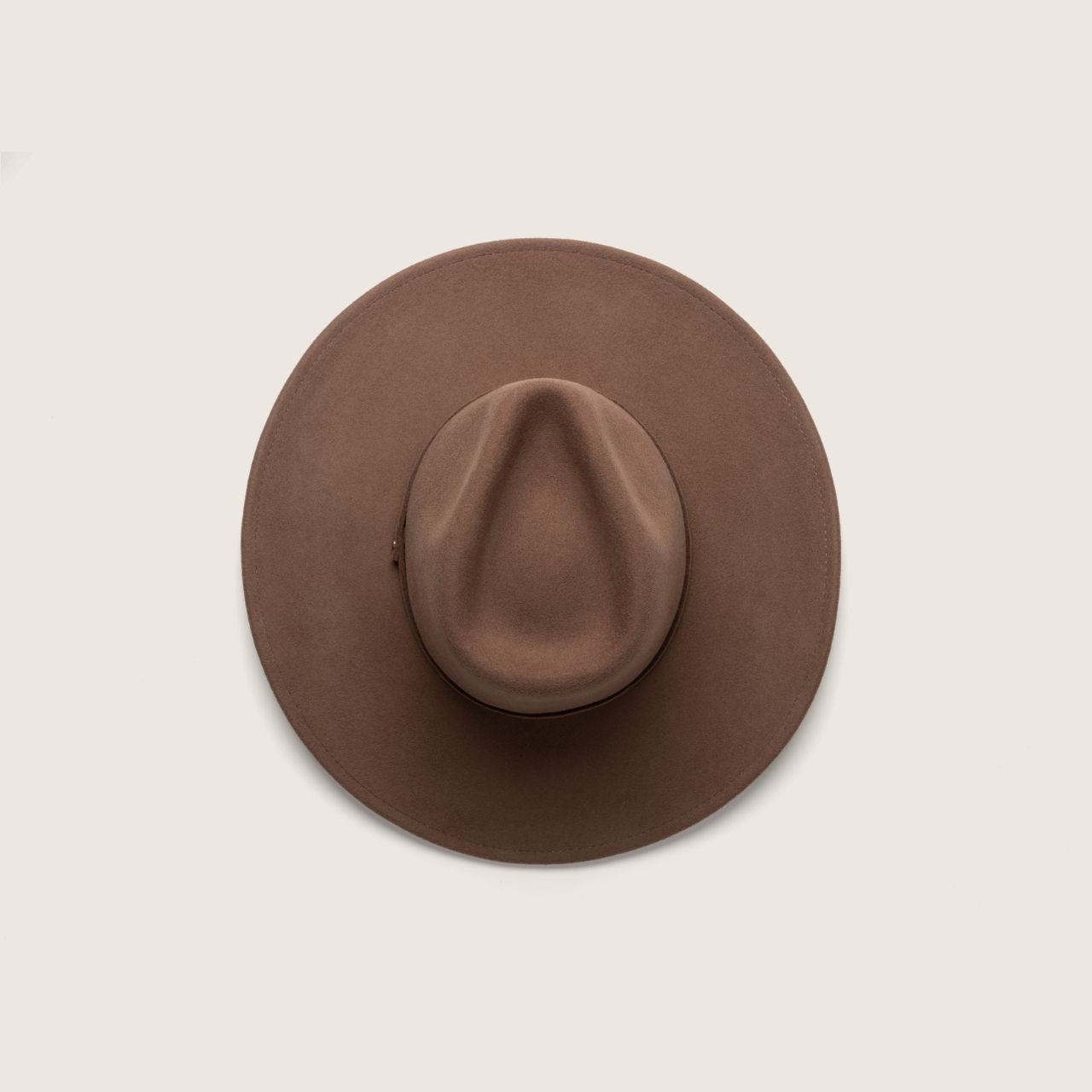 Front view of dusty brown outback hat with wide brim and structured crown on male model