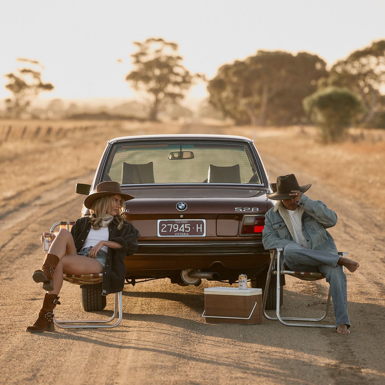 Dusty brown outback hat held by model showing packable design and flexible brim construction