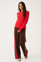 Front view of Dusty Pant in truffle brown with red side stripe detail showing elastic waistband and relaxed fit