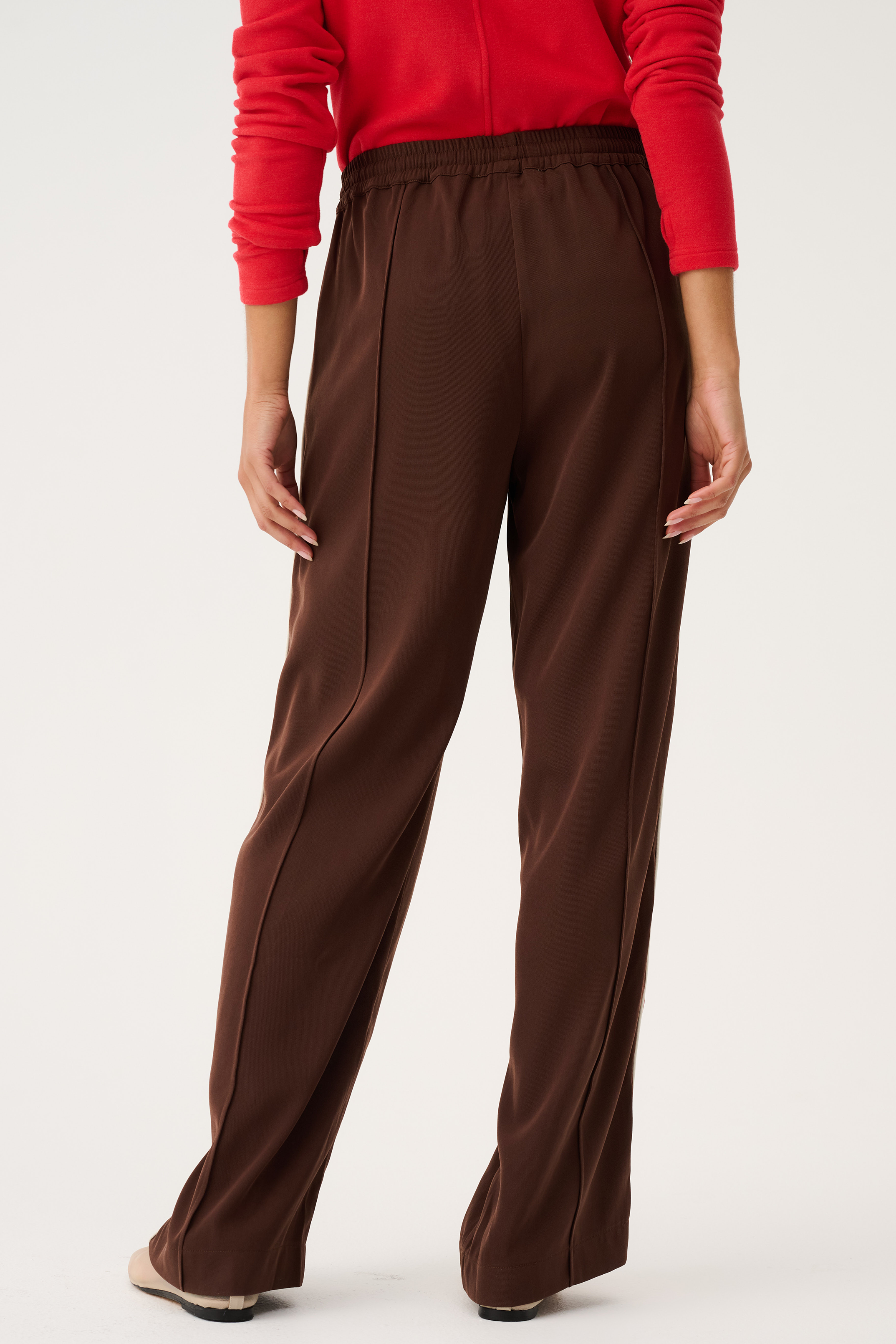 Back view of Dusty Pant in truffle brown showing straight leg silhouette and high-rise elastic waistband