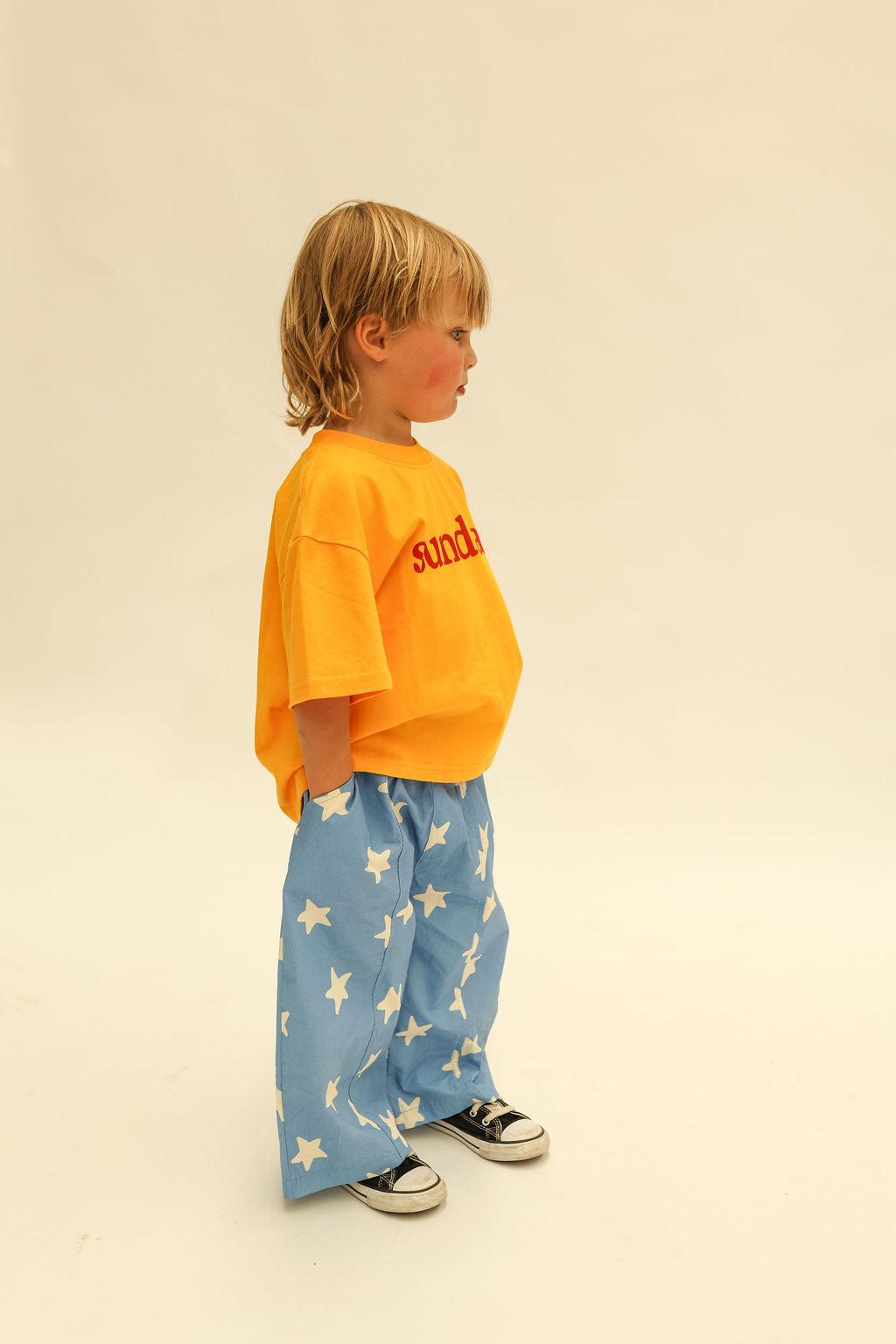 Side view of Dusty Star Pants in cobalt blue with cream star print and wide leg silhouette