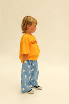 Side view of Dusty Star Pants in cobalt blue with cream star print and wide leg silhouette