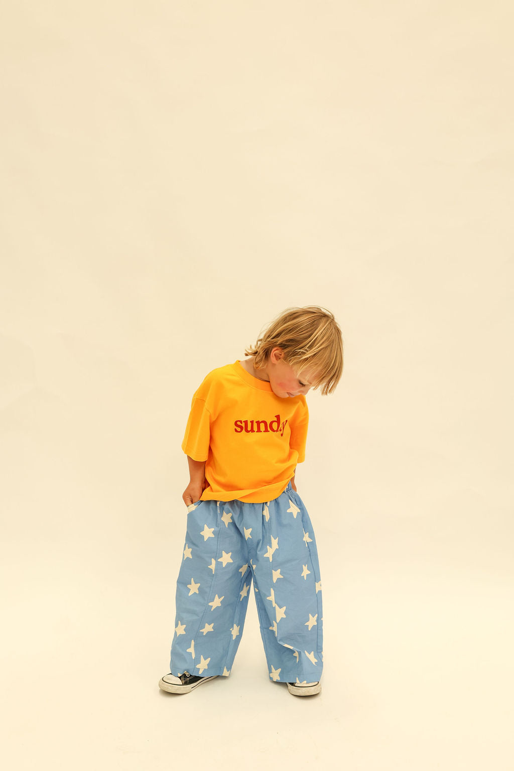 Front view of Dusty Star Pants showing relaxed fit and all-over star pattern in cobalt blue