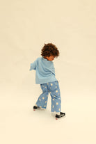 Full body view of cobalt blue Dusty Star Pants with cream stars in relaxed wide leg style