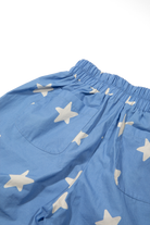 Close-up detail of Dusty Star Pants elastic waistband and cream star print on cobalt fabric