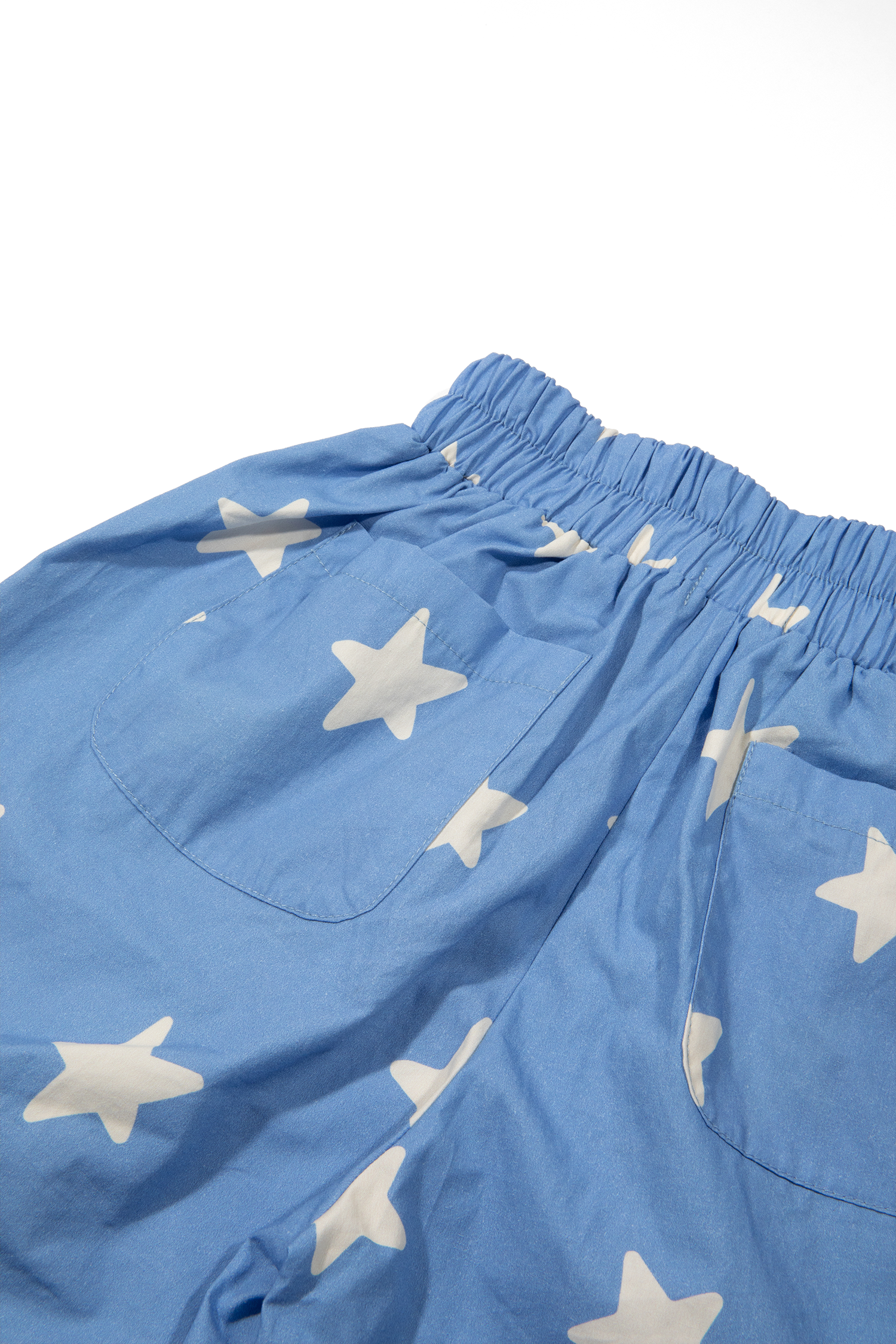 Close-up detail of Dusty Star Pants elastic waistband and cream star print on cobalt fabric