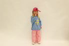 Back three-quarter view of pink Dusty Star Pants with yellow stars and elastic waistband