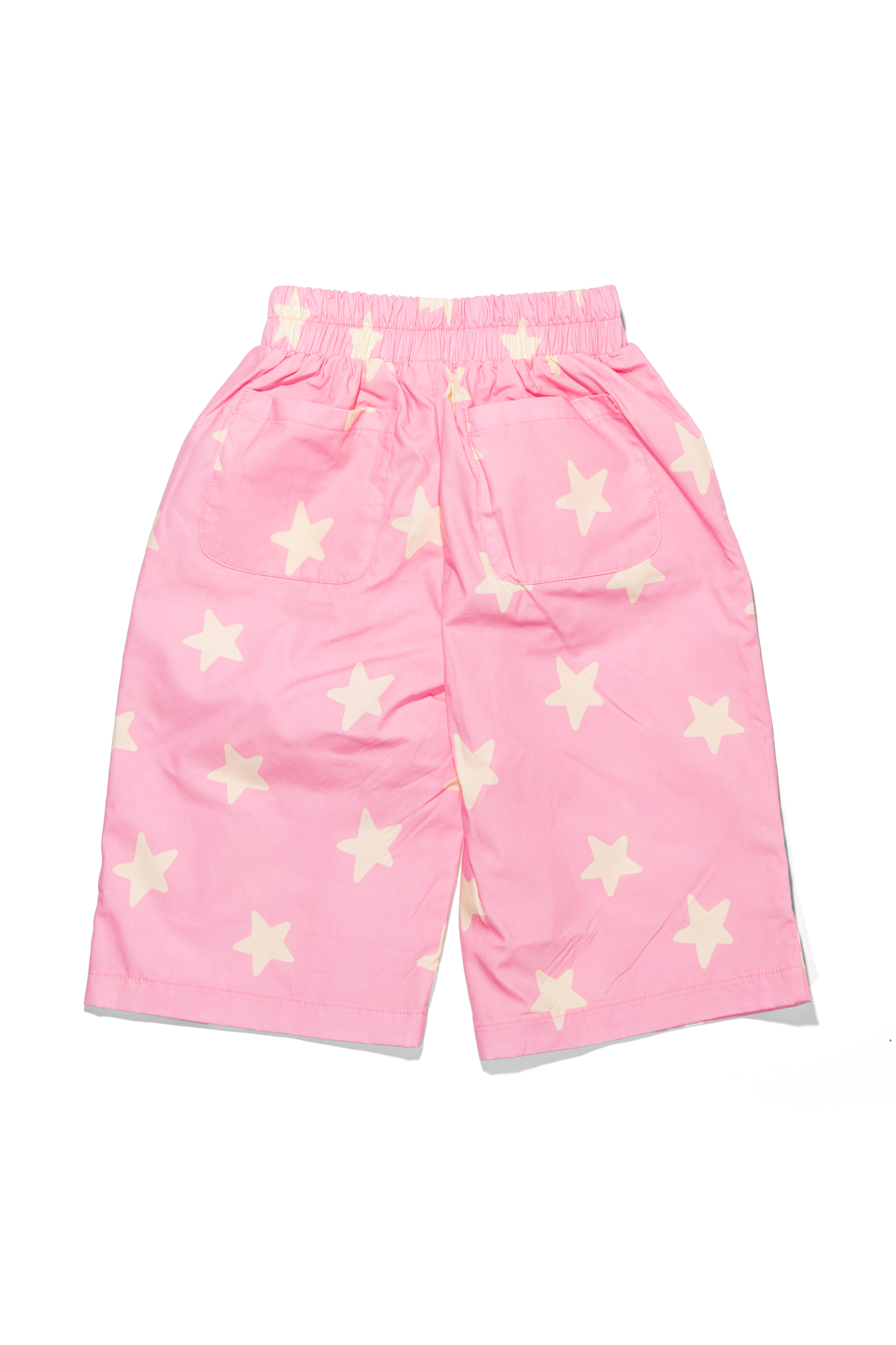 Movement shot of Dusty Star Pants in pink showing flowing wide-leg silhouette with star print